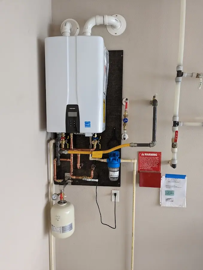 Professional plumber installing copper piping in a Cedar City home